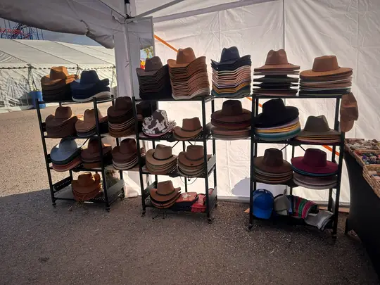 Racks of cowboy hats in every shade at the Black Country Rose stall