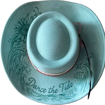 Turquoise hat with crashing waves, a sunflower and “Dance the Tide” burned into the brim