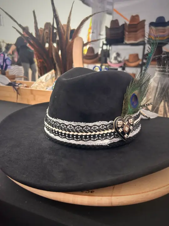 Black hat with lace band, peacock feather and heart charm