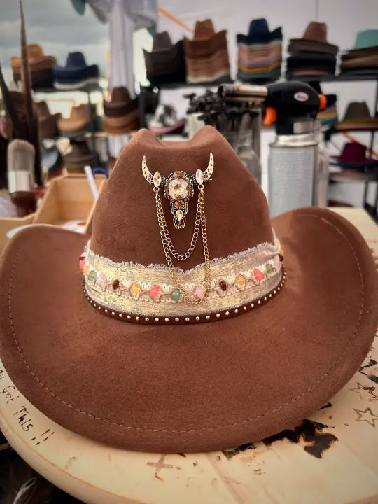 Brown hat with jewelled band and bull skull charm with chains