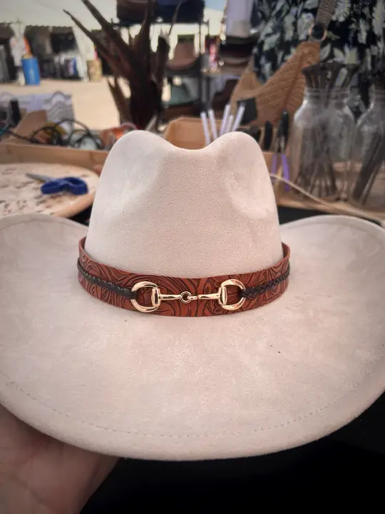 Cream hat with tooled leather band and horse bit