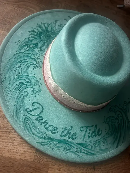 Close-up of the burned wave design on a turquoise brim